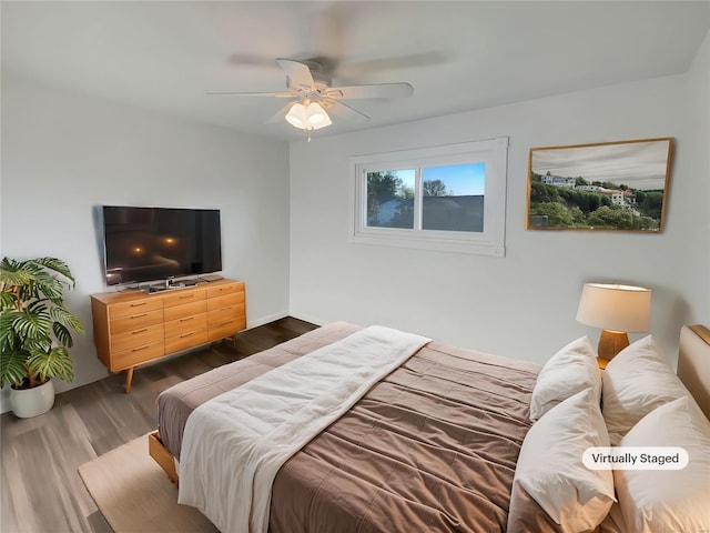 bedroom with a ceiling fan and dark wood finished floors