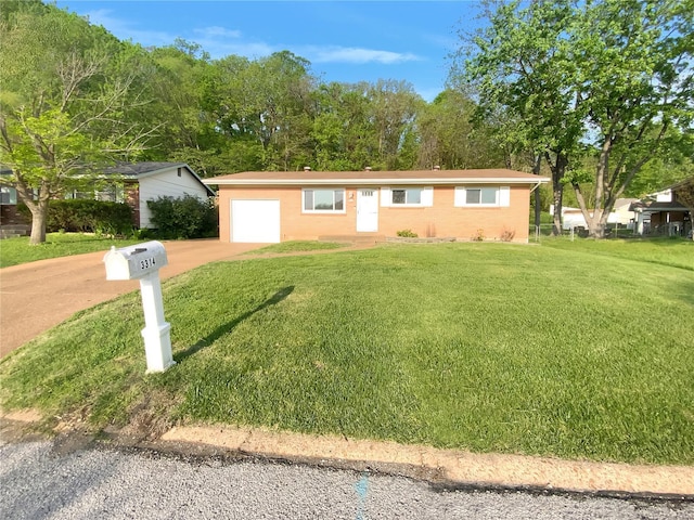 single story home featuring an attached garage, driveway, and a front yard