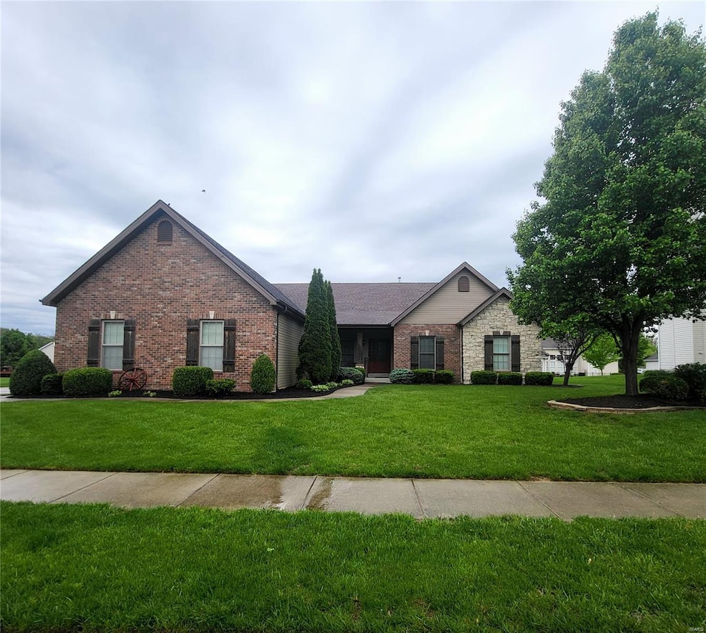 single story home with brick siding and a front lawn