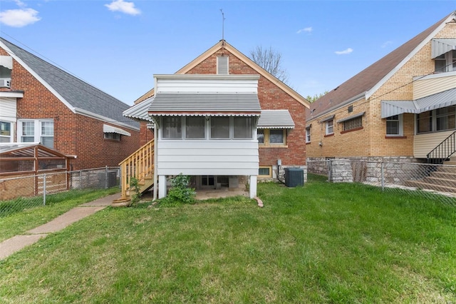back of property with fence, a yard, and cooling unit