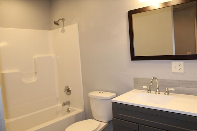 full bathroom featuring vanity, backsplash, bathing tub / shower combination, and toilet