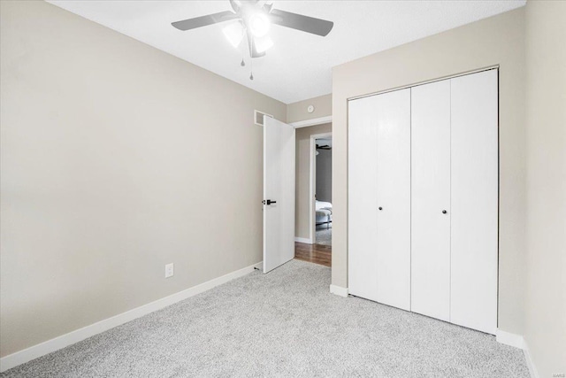 unfurnished bedroom with light colored carpet, baseboards, visible vents, and a closet