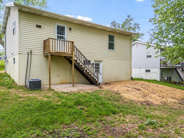 back of property with a lawn, central AC unit, stairs, and a wooden deck