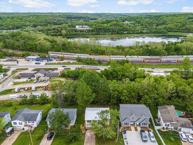 birds eye view of property featuring a water view and a view of trees
