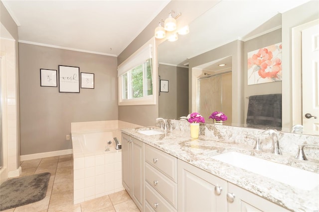 bathroom with tile patterned flooring, a shower stall, a sink, and a garden tub