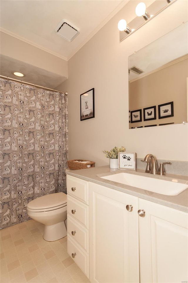 bathroom with crown molding, vanity, toilet, and visible vents