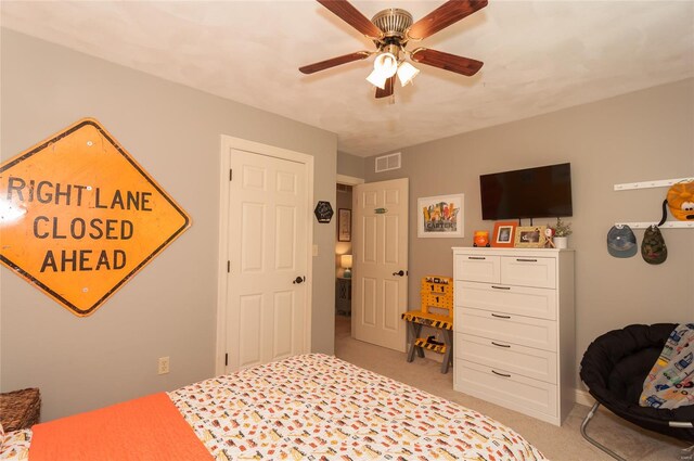 bedroom featuring ceiling fan, light colored carpet, and visible vents