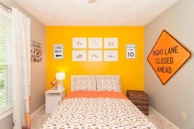 bedroom with baseboards and carpet