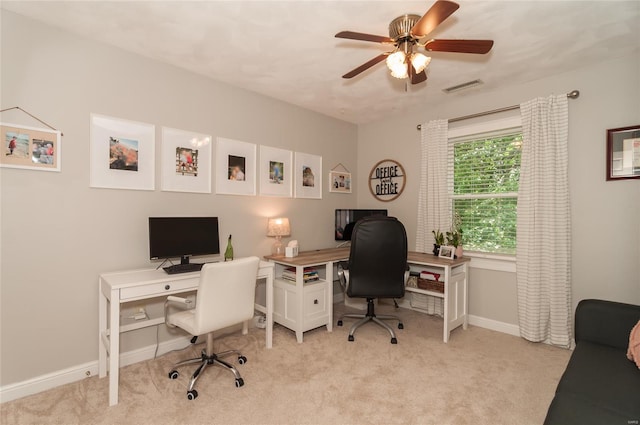 office with baseboards, ceiling fan, light colored carpet, and visible vents