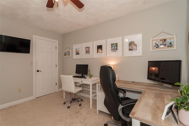 office featuring carpet floors, a ceiling fan, and baseboards
