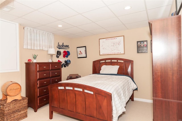 bedroom featuring light colored carpet, recessed lighting, baseboards, and a drop ceiling