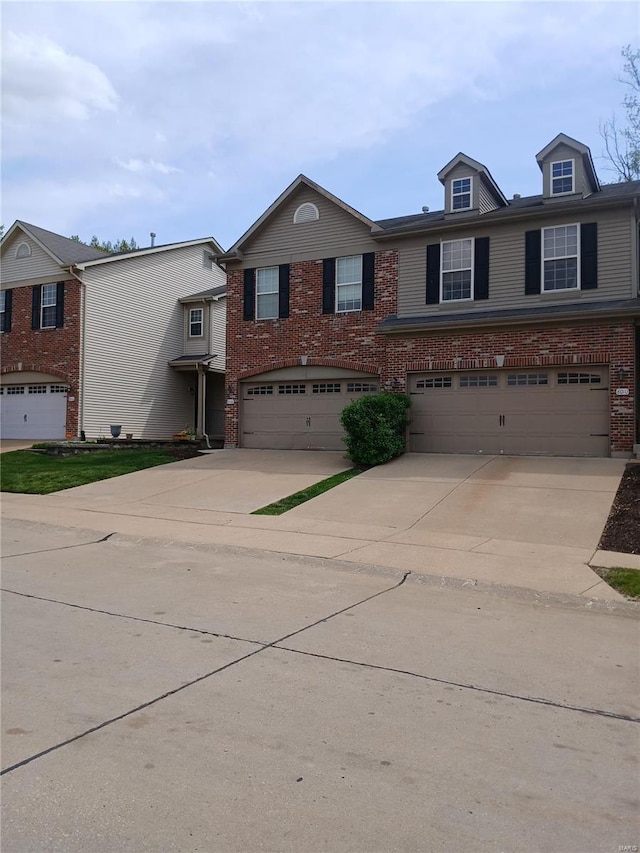view of front of property featuring concrete driveway, brick siding, and a garage