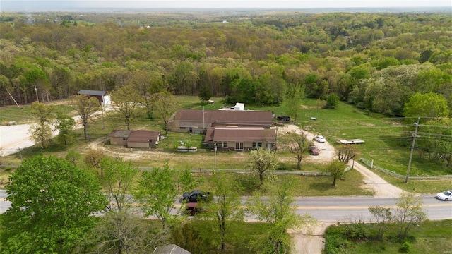 drone / aerial view with a wooded view