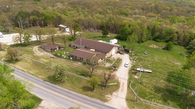 birds eye view of property featuring a wooded view