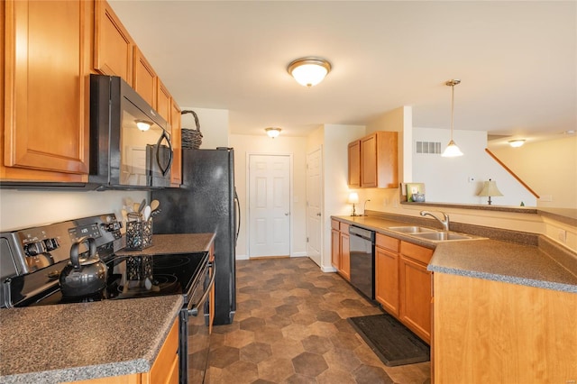 kitchen with visible vents, a peninsula, dark countertops, a sink, and black appliances