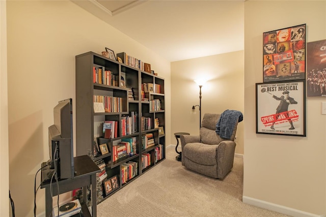 living area featuring carpet floors and baseboards