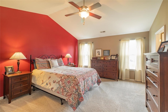 carpeted bedroom featuring visible vents, a ceiling fan, multiple windows, and lofted ceiling