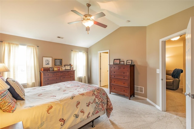 bedroom featuring visible vents, baseboards, lofted ceiling, and light carpet