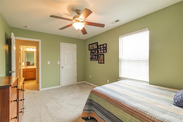 bedroom with light colored carpet, a ceiling fan, baseboards, and visible vents