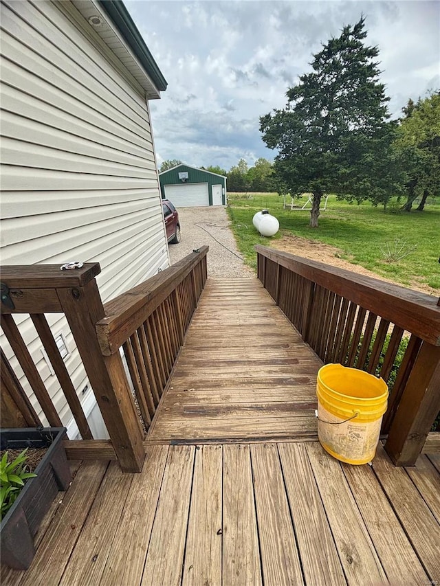 deck featuring a yard and an outdoor structure