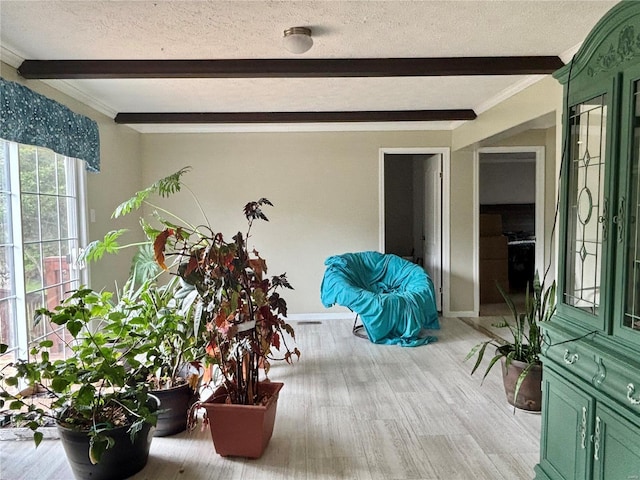 sunroom / solarium featuring beamed ceiling