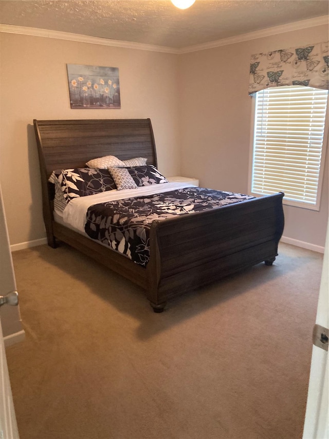 carpeted bedroom with crown molding, baseboards, and a textured ceiling