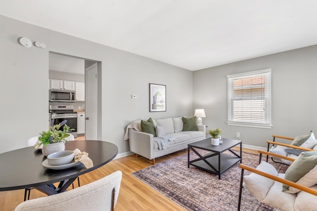 living room featuring baseboards and light wood-style flooring