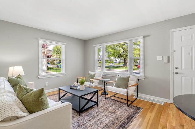 living room with plenty of natural light, baseboards, and visible vents