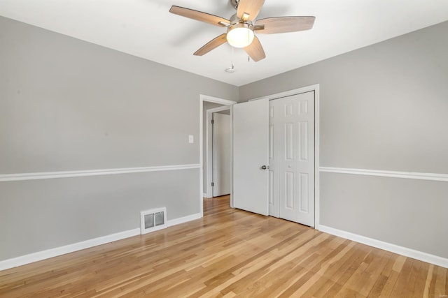 unfurnished bedroom with light wood-style floors, baseboards, a closet, and visible vents