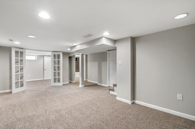 basement featuring carpet floors, french doors, recessed lighting, baseboards, and visible vents