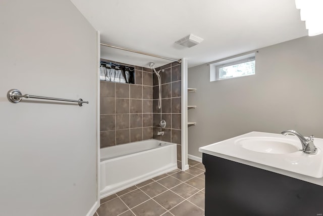 bathroom featuring tile patterned flooring, visible vents, baseboards, bathtub / shower combination, and a sink