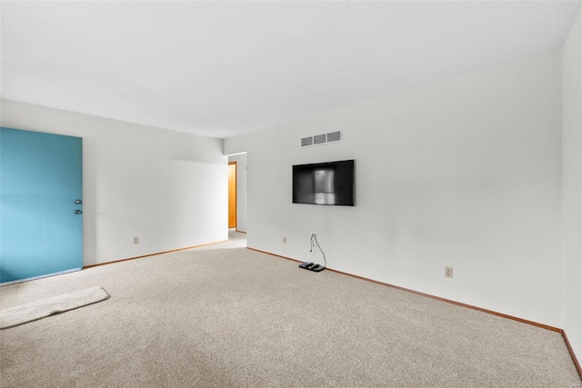 carpeted spare room featuring baseboards and visible vents