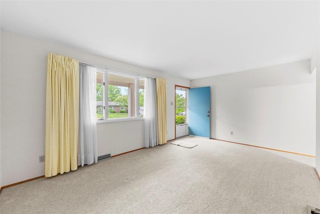 carpeted empty room with baseboards