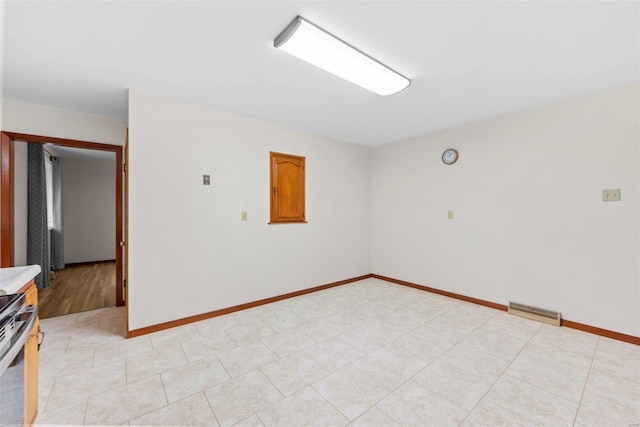 spare room featuring baseboards and visible vents