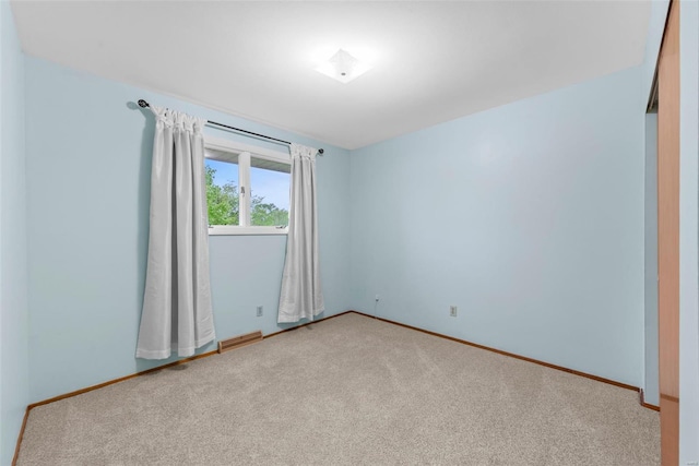 spare room with carpet flooring and baseboards