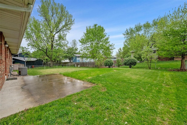 view of yard with central AC unit, a patio area, and a fenced backyard