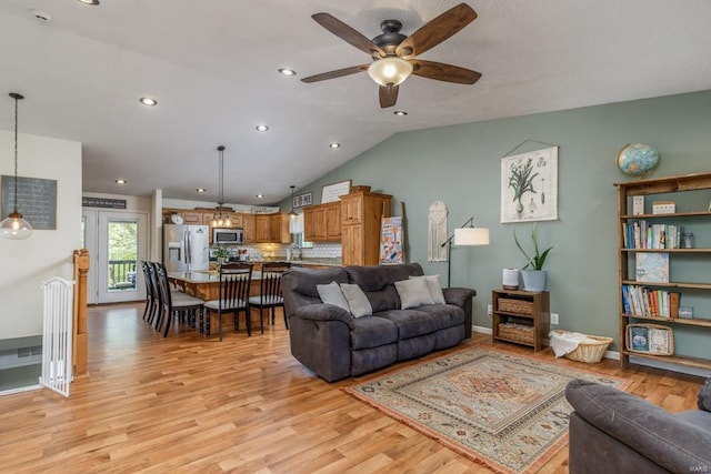 living room featuring recessed lighting, ceiling fan, lofted ceiling, and light wood-style floors