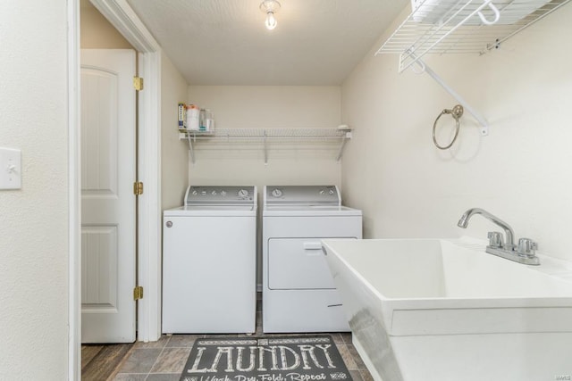 laundry room featuring a sink, laundry area, and washer and clothes dryer