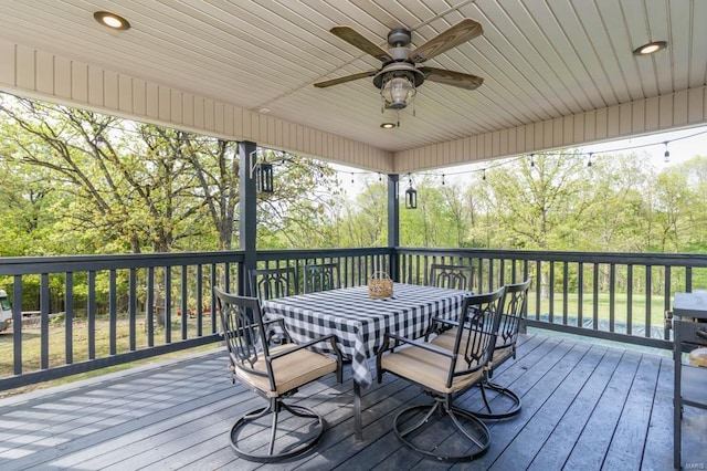 wooden deck with a ceiling fan and outdoor dining space