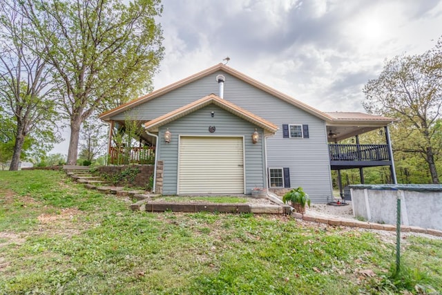 back of house with a lawn and ceiling fan