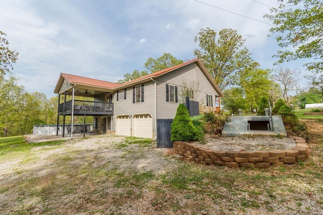 view of side of home with a ceiling fan and a garage