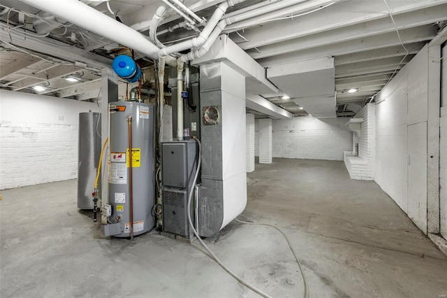 unfinished basement featuring heating unit, water heater, and gas water heater