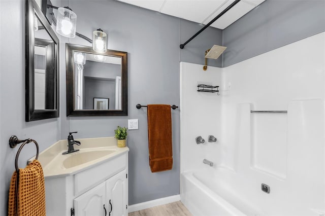 bathroom featuring shower / bathtub combination, wood finished floors, and vanity