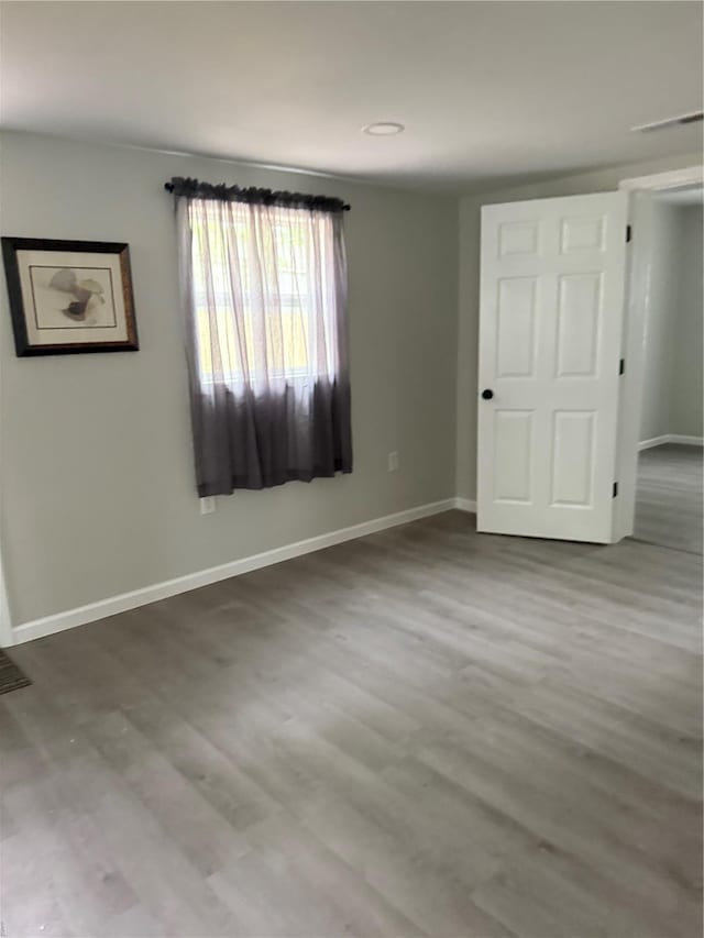 unfurnished bedroom featuring baseboards and wood finished floors