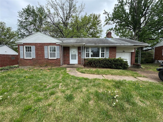 view of front of house with brick siding, a garage, a front lawn, and a chimney