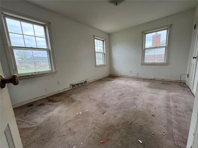 empty room with visible vents, carpet flooring, and baseboards