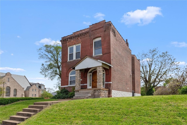 view of front of house featuring brick siding, stone siding, and a front yard