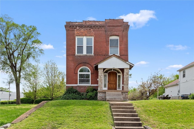 view of front of house featuring a front yard and brick siding