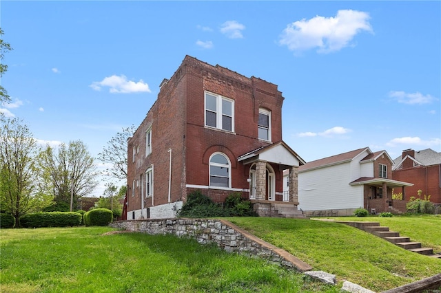 view of front of property with brick siding and a front yard