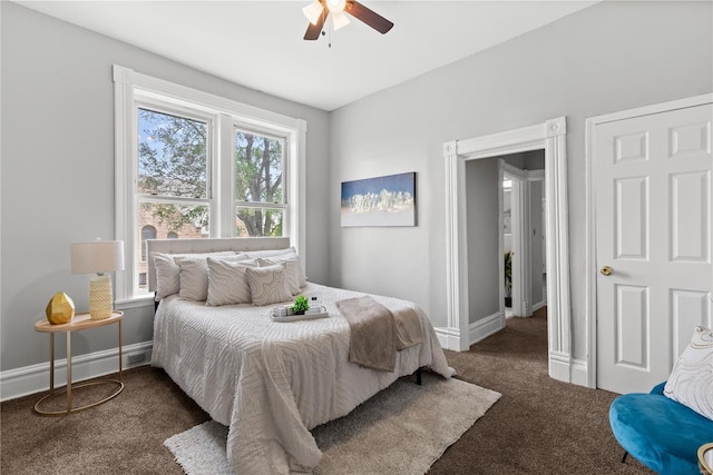 carpeted bedroom with a ceiling fan and baseboards